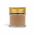 Black Winter Truffle powder made from Tuber brumale in a clear glass jar with a yellow lid