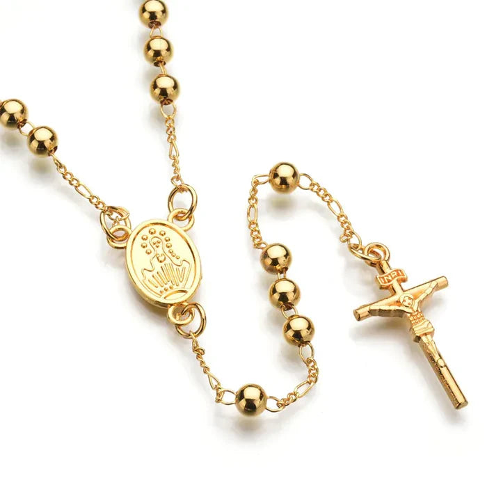 Close-up of beaded chain on cross pendant necklace