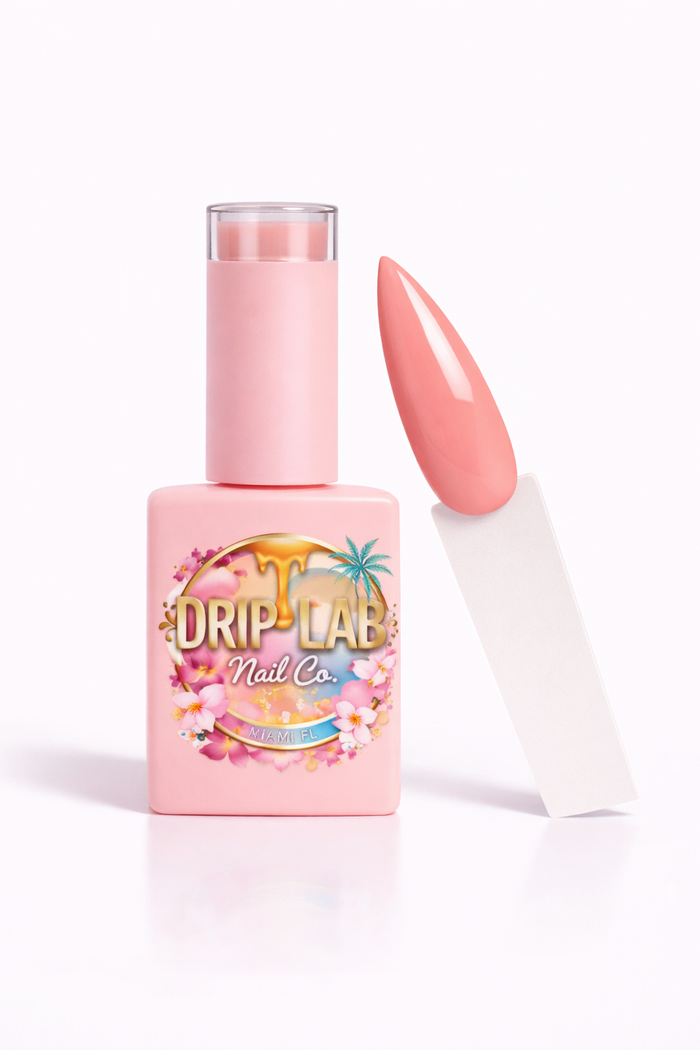 Pink gel nail polish bottle with a matching nail on a white background, featuring 'Drip Lab Nail Co.' branding.