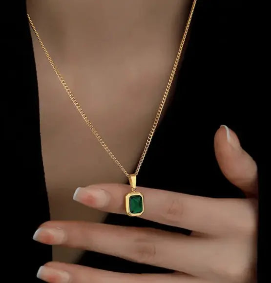 Emerald green pendant necklace on gold clavicle chain