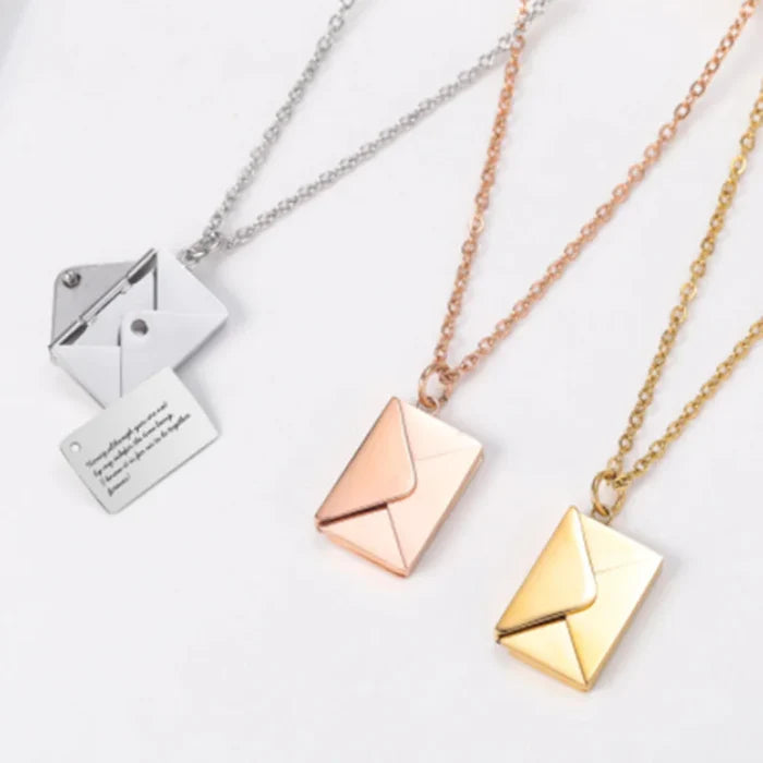 Close-up of envelope pendant detail in rose gold