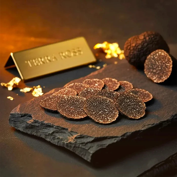 Thin fresh Tuber melanosporum slices showing natural marbling and shape variation