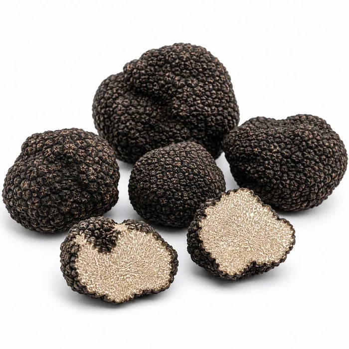 Whole and cut fresh Tuber aestivum A Grade truffles with pale hazelnut interiors and fine marbling