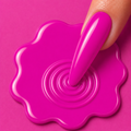 Close-up of a hand with pink nail polish on a pink background