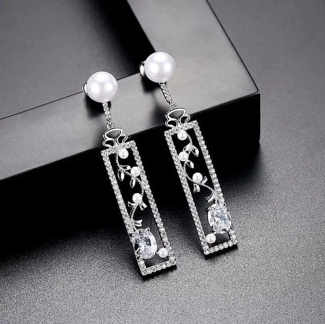 Close-up of pearl detail on long drop earrings