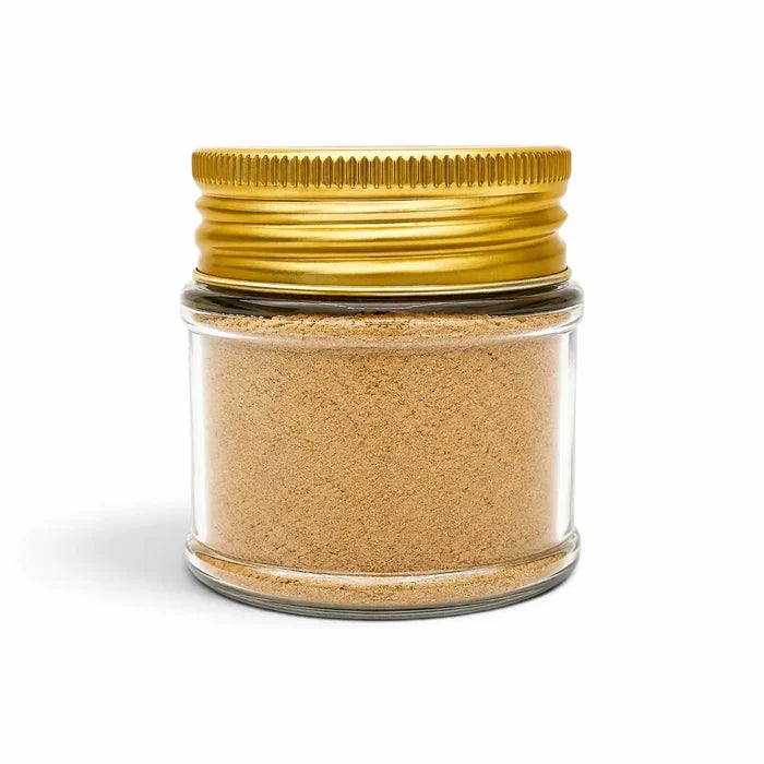 Morel powder (Morchella esculenta) in a clear glass jar with a gold lid