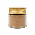 Spring white truffle powder (Tuber borchii) in a clear glass jar with a yellow lid